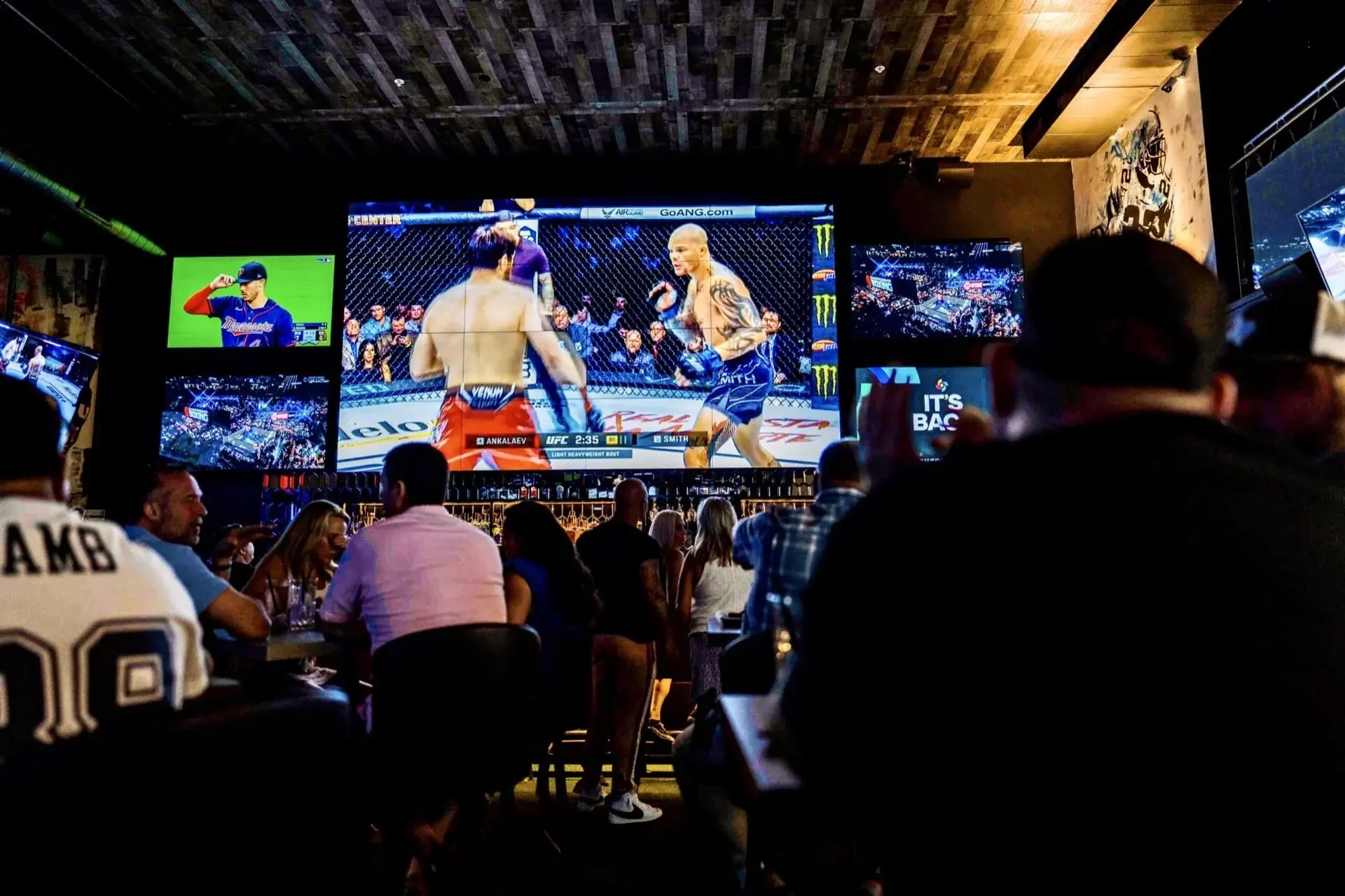 Sports fans enjoying a UFC night at G.O.A.T's Arena