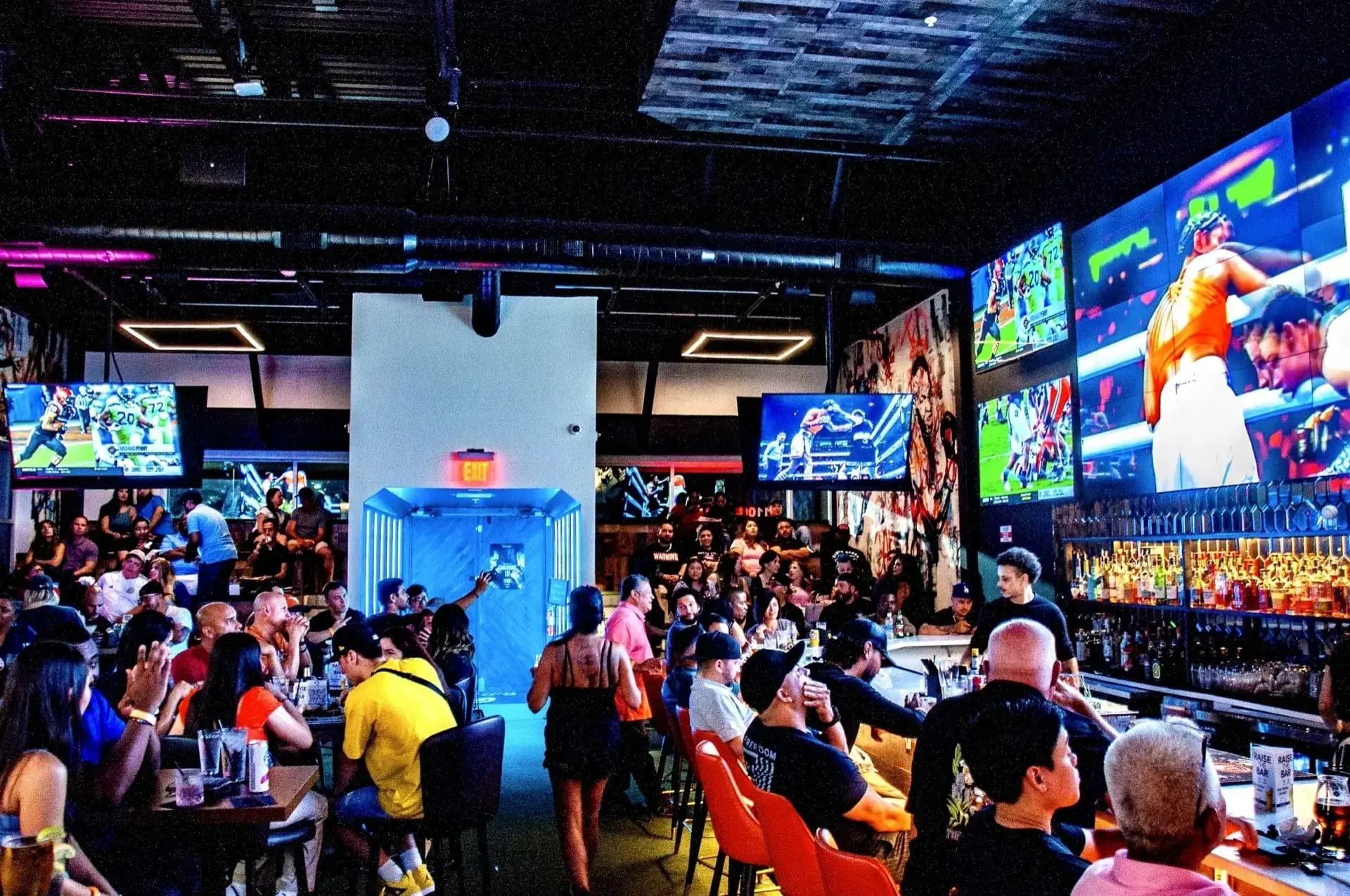 Fans cheering during an NFL playoff game at G.O.A.T's Arena